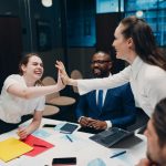 Businessman and businesswoman team at office meeting. Business people group conference high five